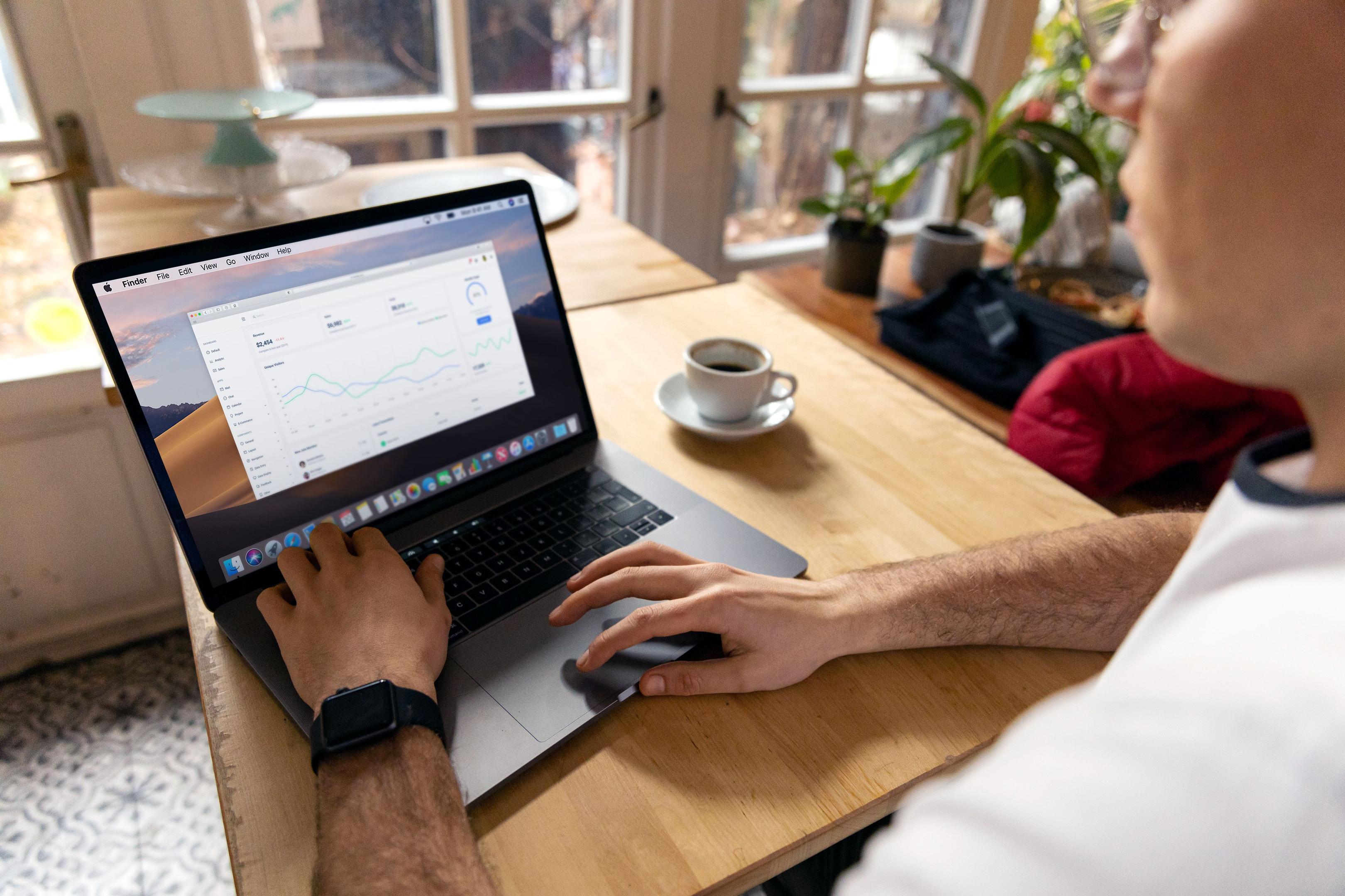 A restaurant owner is intently reviewing a tablet displaying order analytics, while staff members prepare food in the background, highlighting the dynamic environment of the restaurant industry. This scene reflects the importance of data in enhancing the customer experience and adapting to emerging food trends.