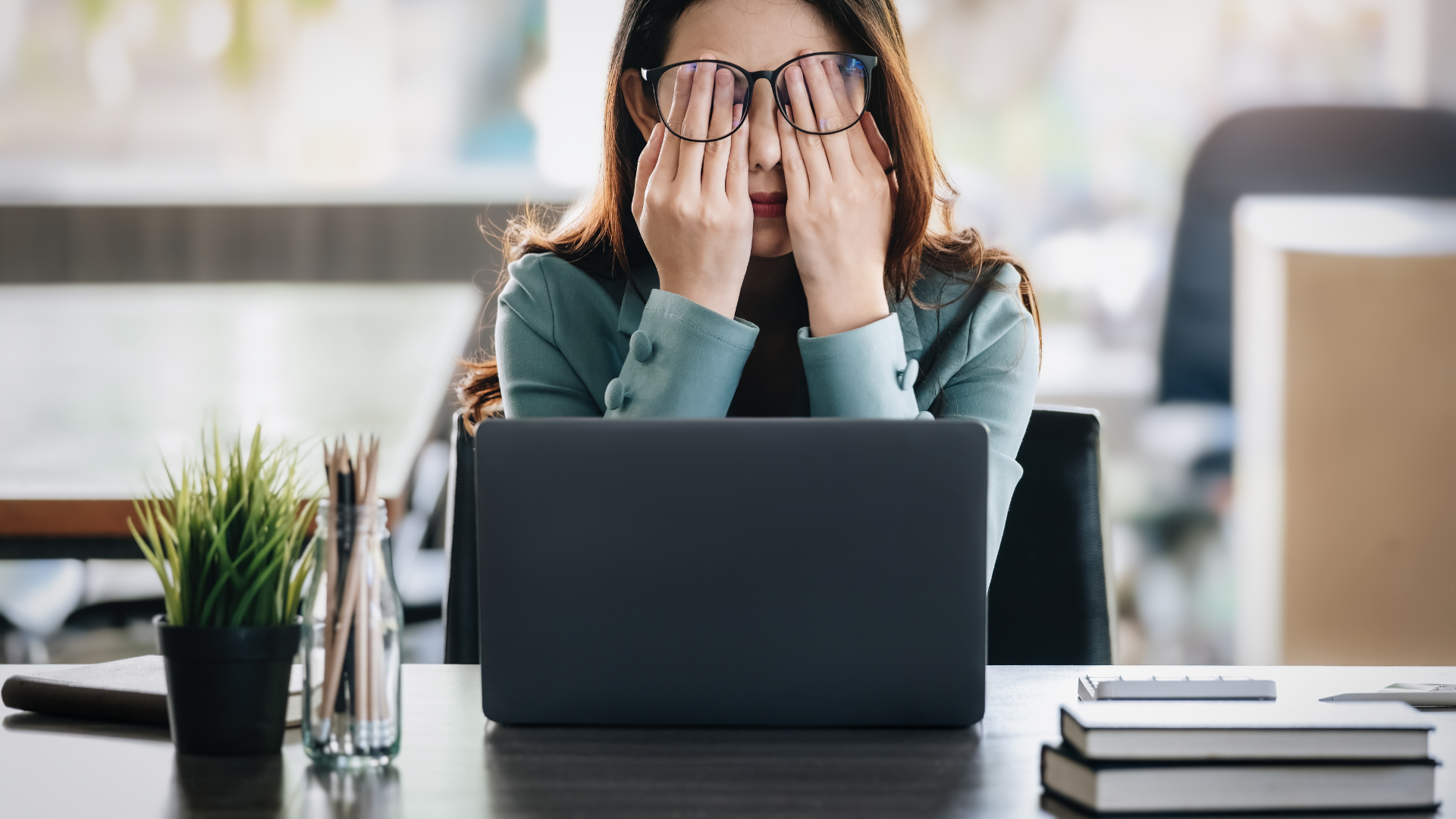 woman sitting in front of her laptop stressed