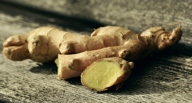 An image of ginger root on a wooden table. 