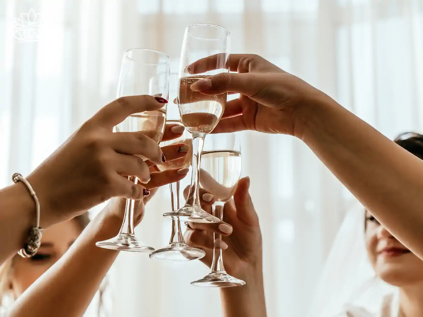 Group of people toasting with champagne flutes in a bright room - Fabulous Flowers and Gifts: Gift Boxes with Champagne and Wine.