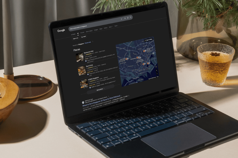 A laptop screen displaying Google search results for "best restaurants in Singapore," highlighting the Google Maps local pack and business listings essential for restaurant SEO.