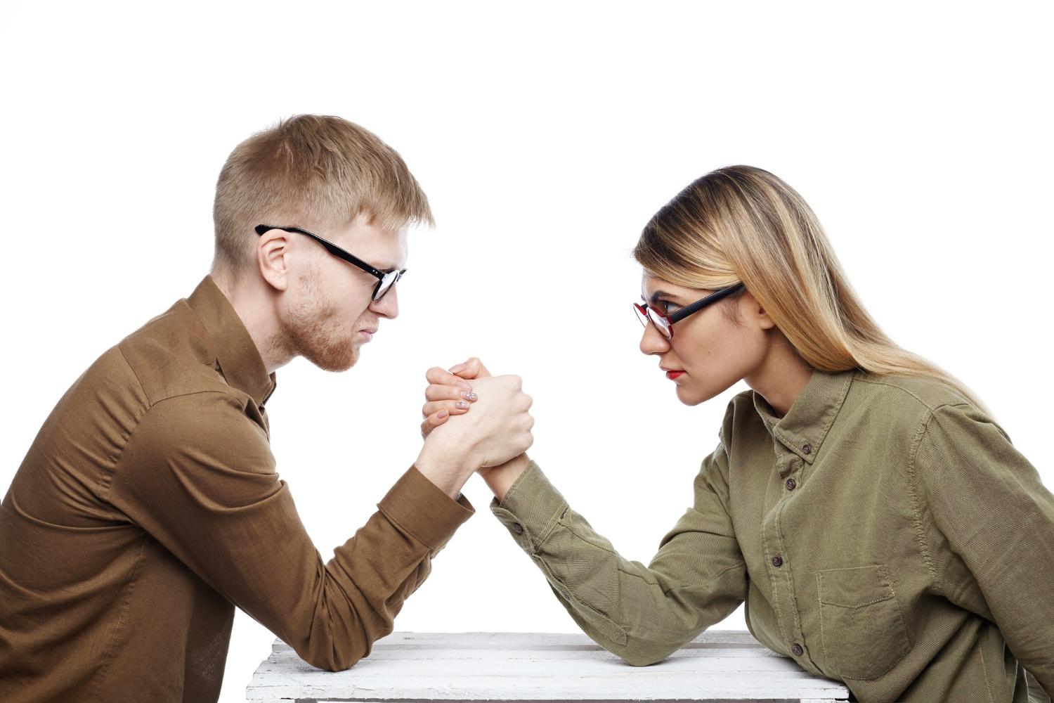 Competitors arm wrestling.