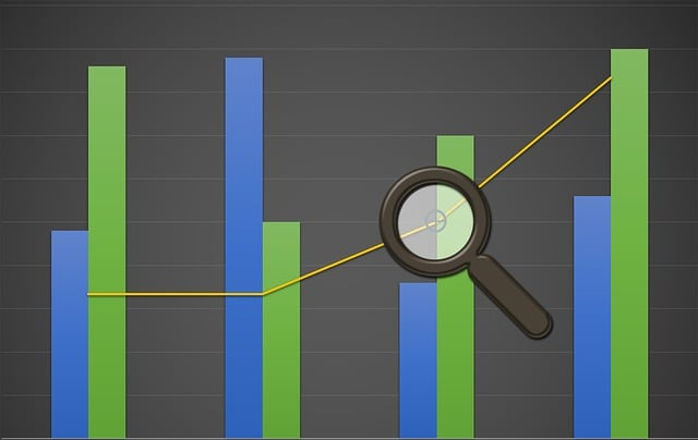 A magnifying glass in front of a chart. The graphics are representing data visualization and valuable insights that can be acquired.