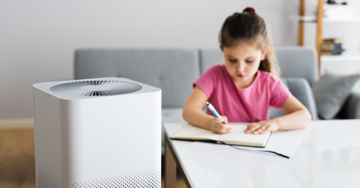Image of a hepa filters air purifier keeping a child safe while they do homework.