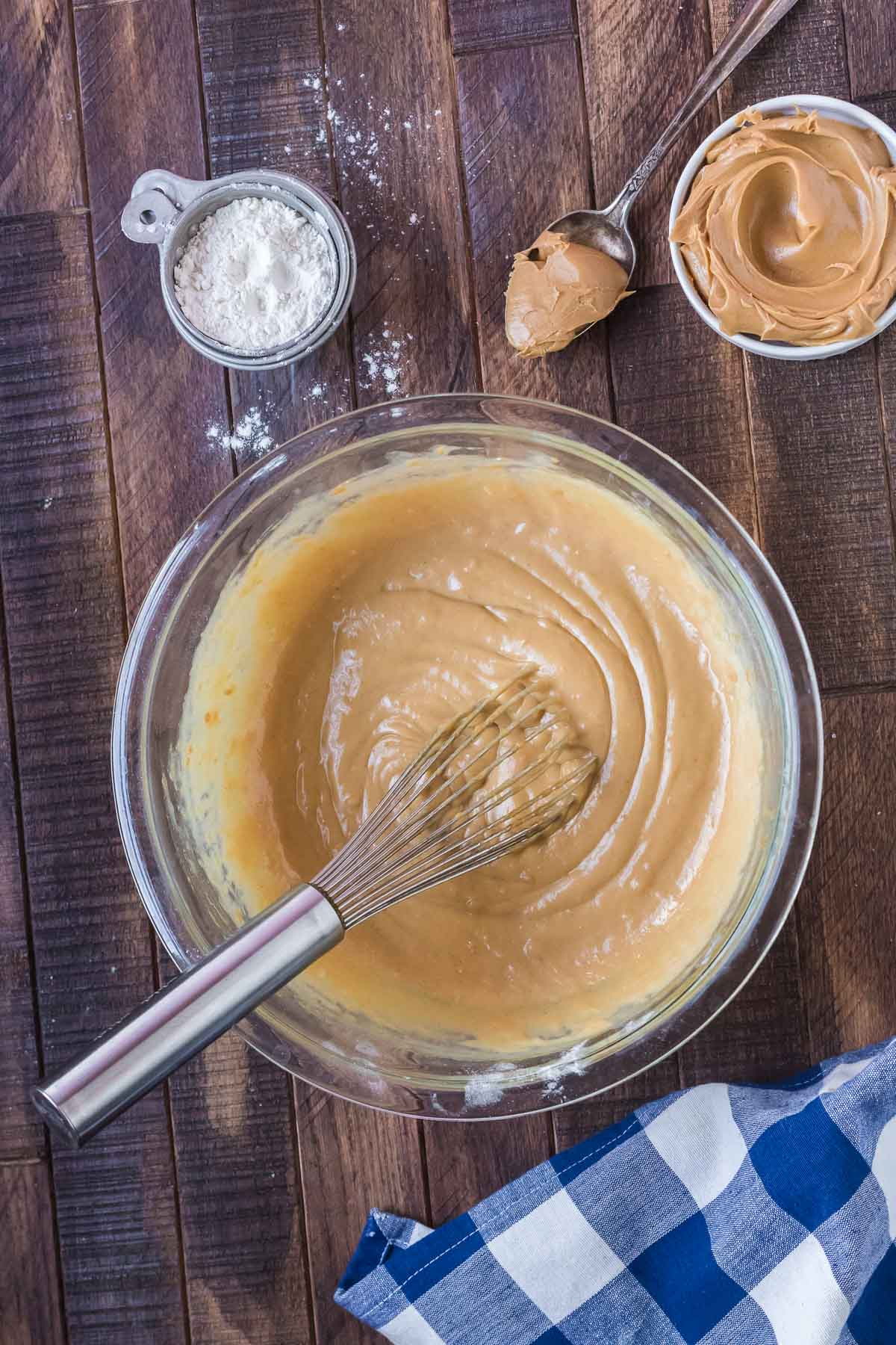 peanut butter bread wet mixture in a bowl with a whisk