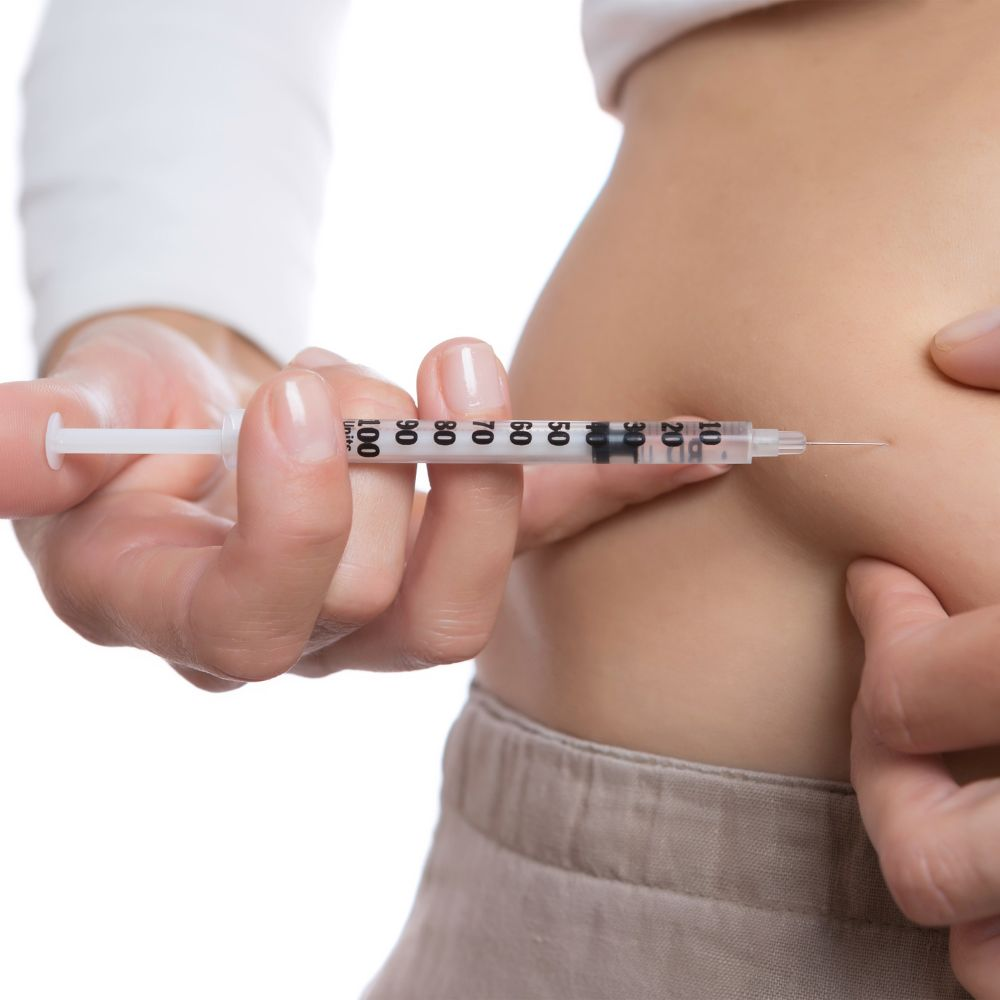 A person taking semaglutide injections to promote weight loss