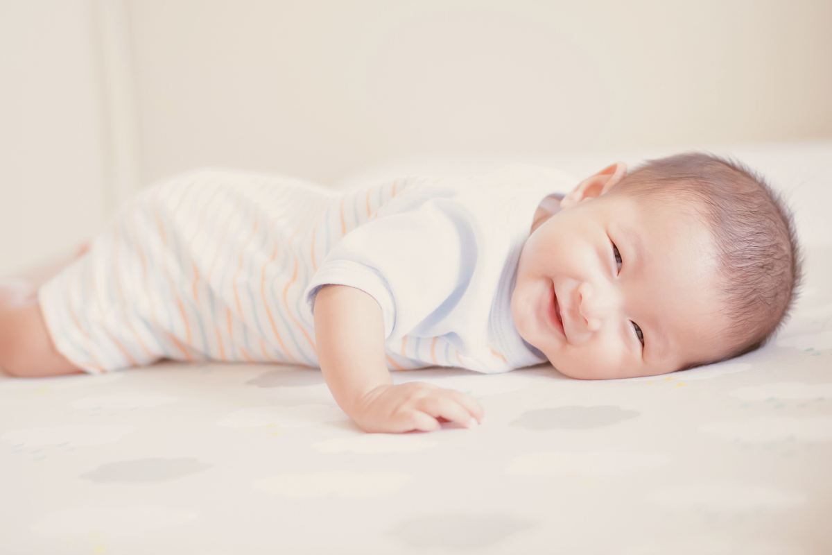 Infant doing tummy time Poppyseed Play