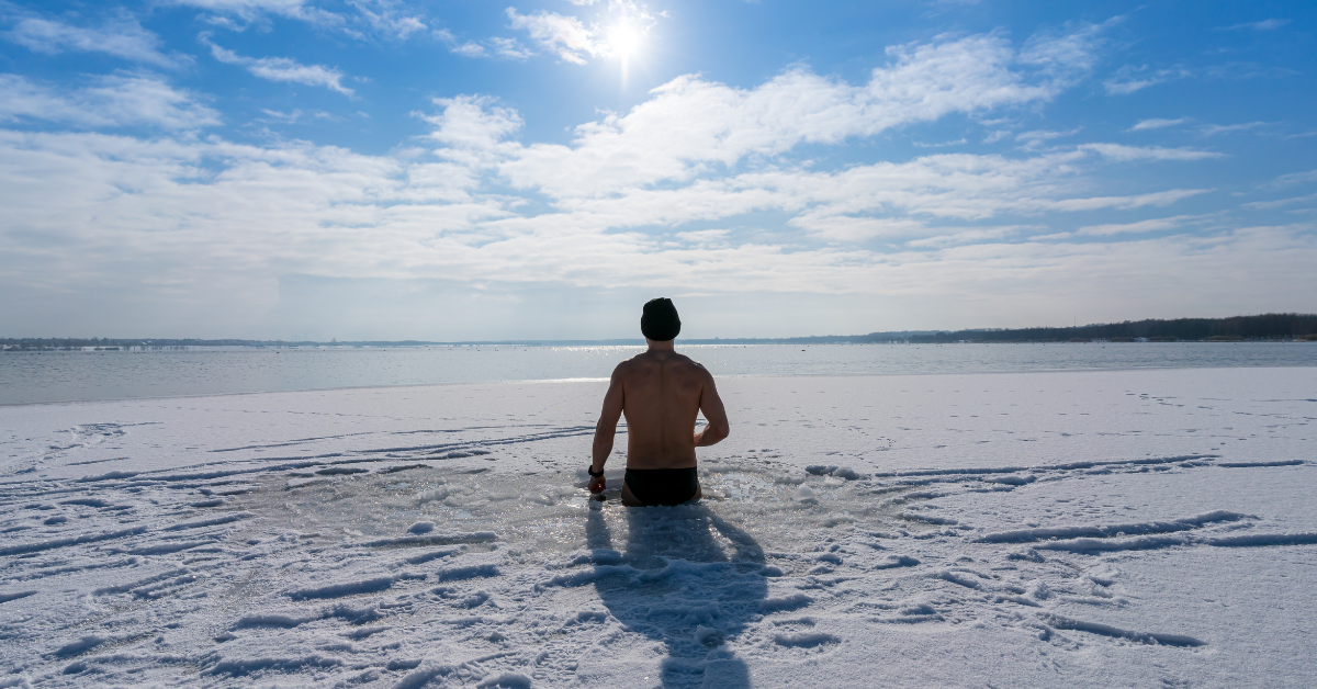 A man in an ice bath experiencing cold plunge benefits.