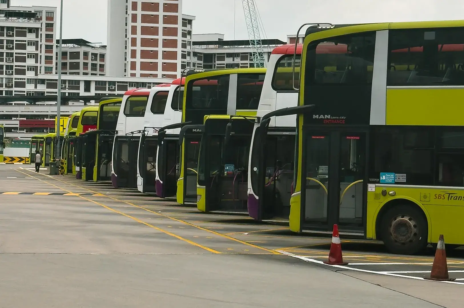 Row of parked buses at transit depot.