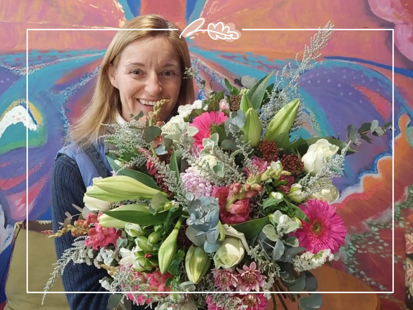 A florist from Fabulous Flowers and Gifts presenting a large, colourful bouquet with pink lilies and white roses. Your Perfect Bouquet of Flowers.