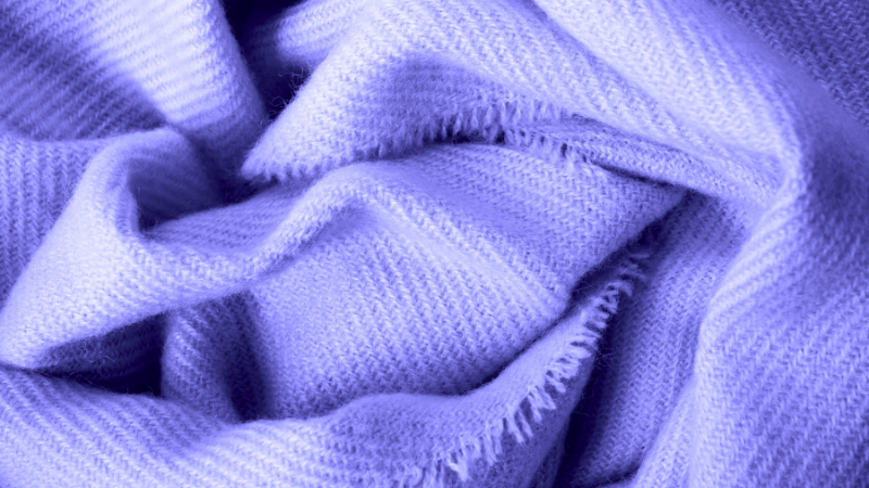 A close-up image of a purple knitted blanket
