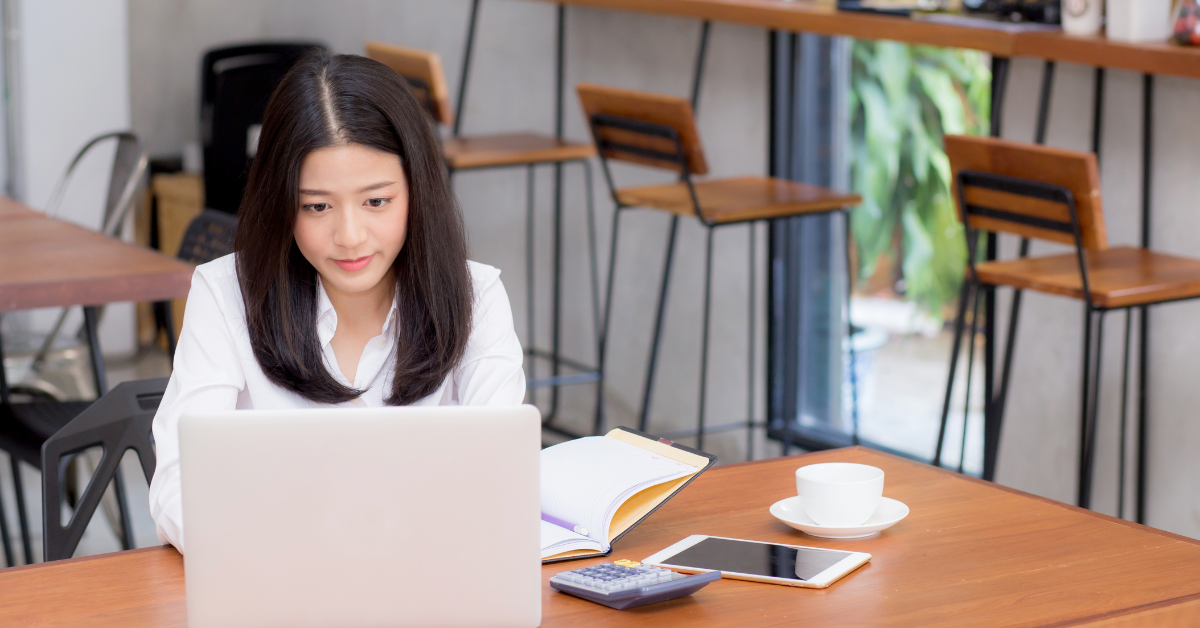 A woman calculating taxes using LLC pass-through rules as an OnlyFans creator.