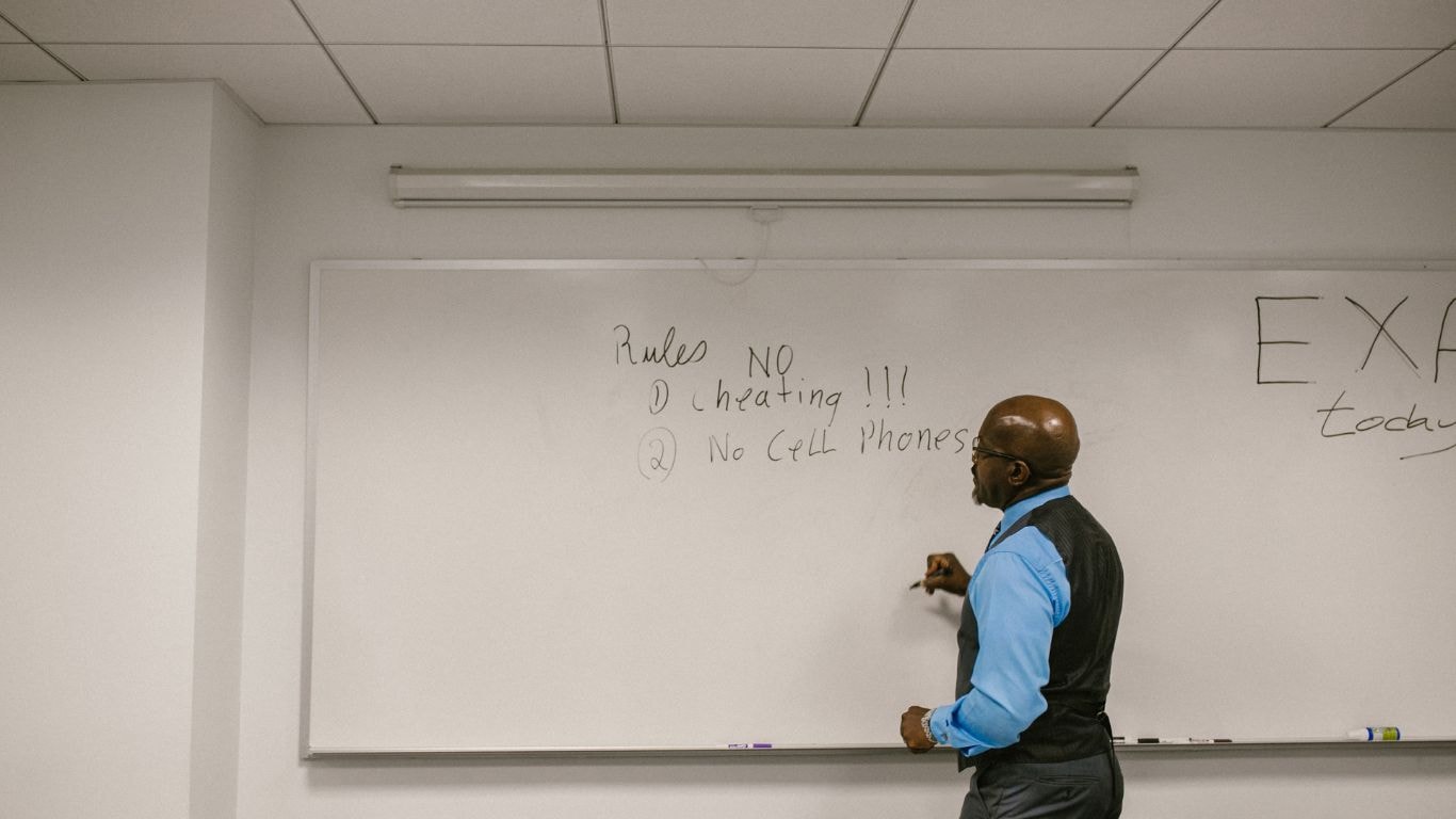 teacher giving student test scores