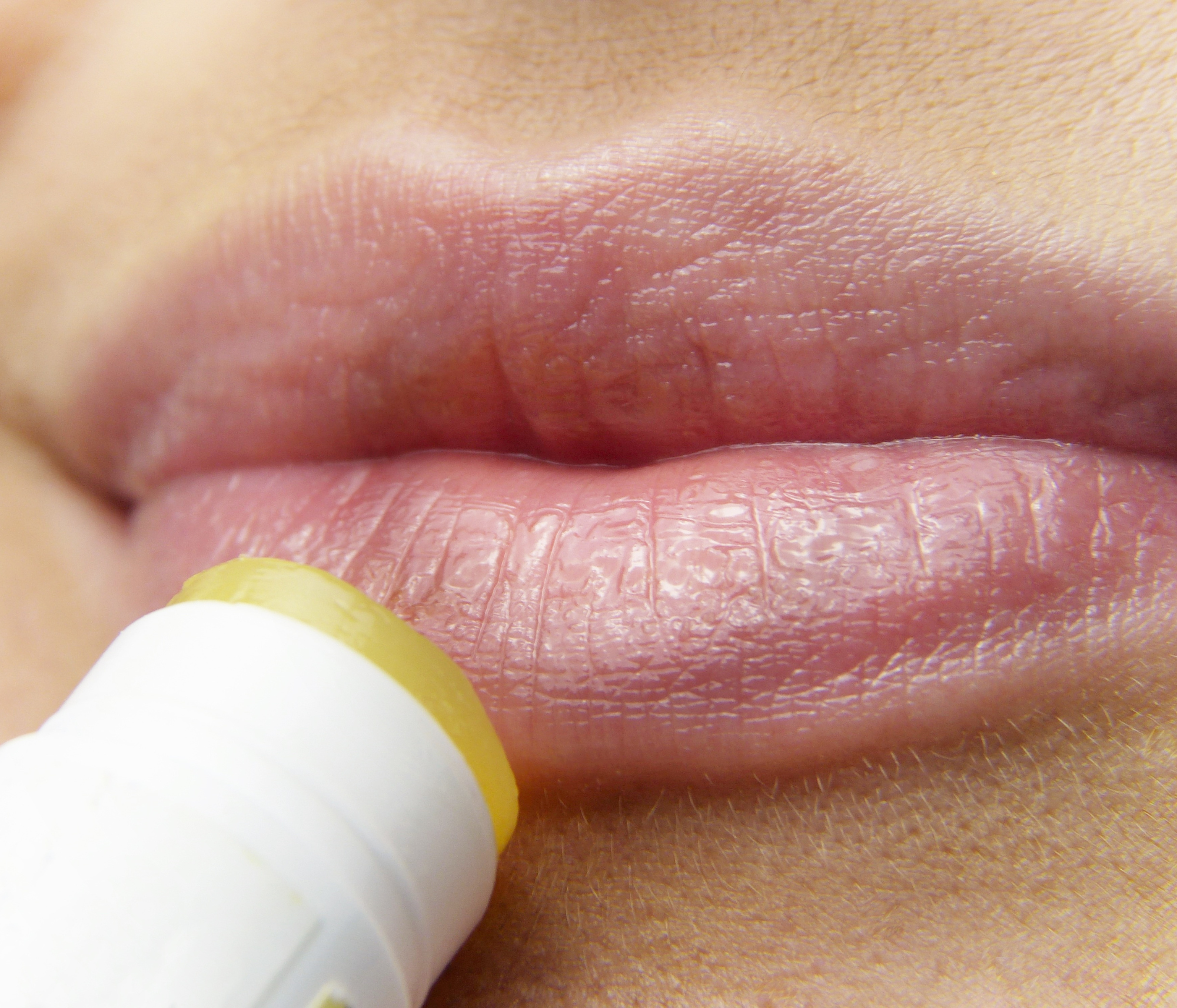 person applying lip balm