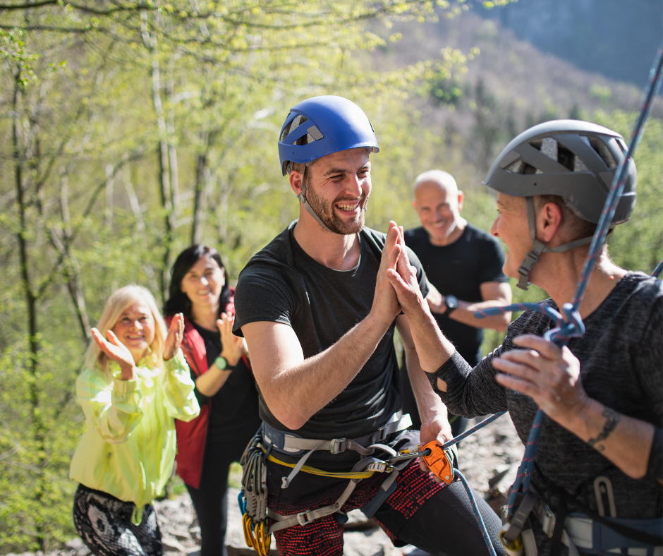 A group of friends rock climbing outdoors