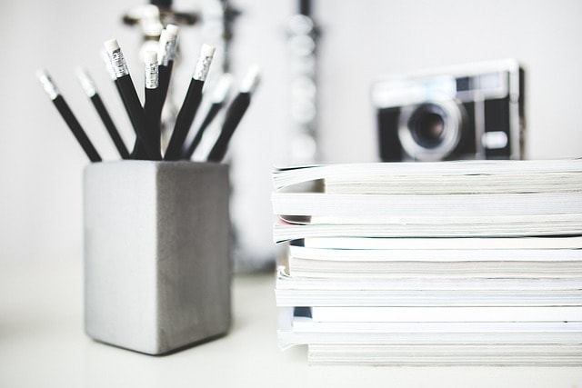A stack of papers and pens.