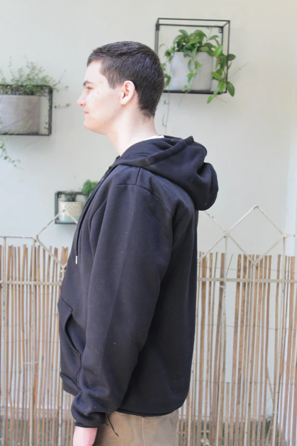 side view of man wearing black bulletproof hoodie