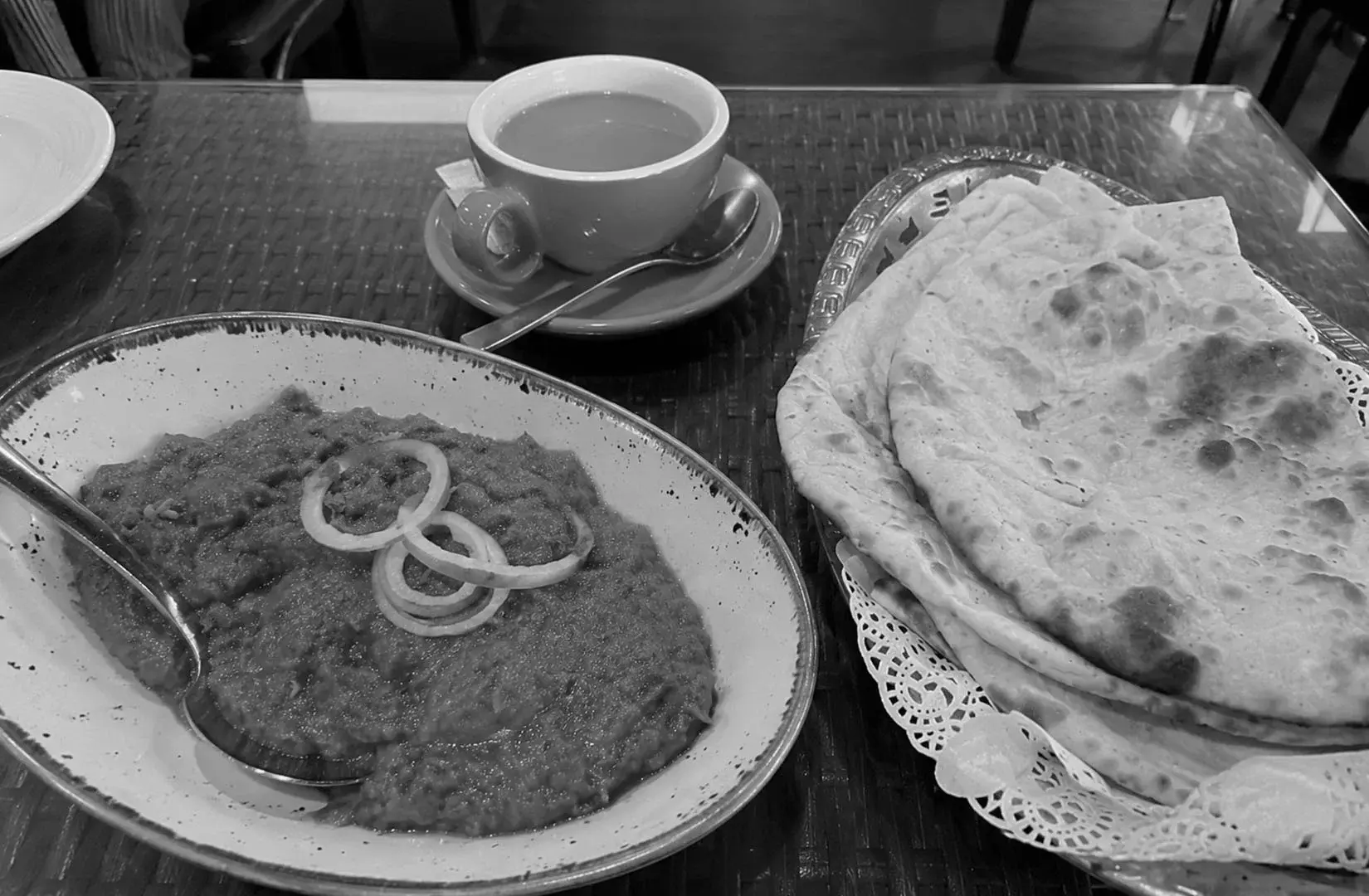 Traditional curry served with freshly baked naan bread and a hot cup of tea.