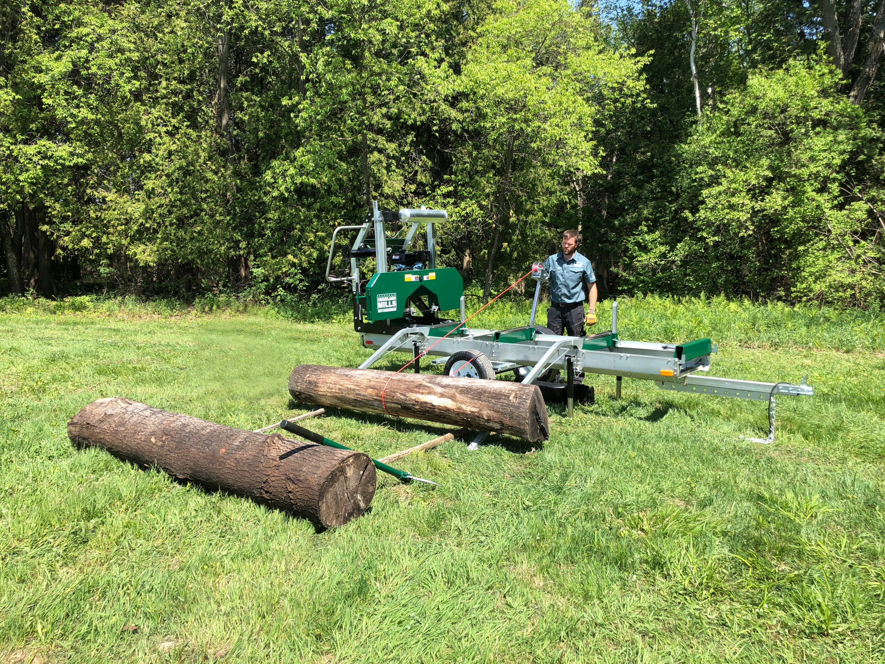 A Woodland Mills portable sawmill being used for a land clearing job to be turned into lumber.