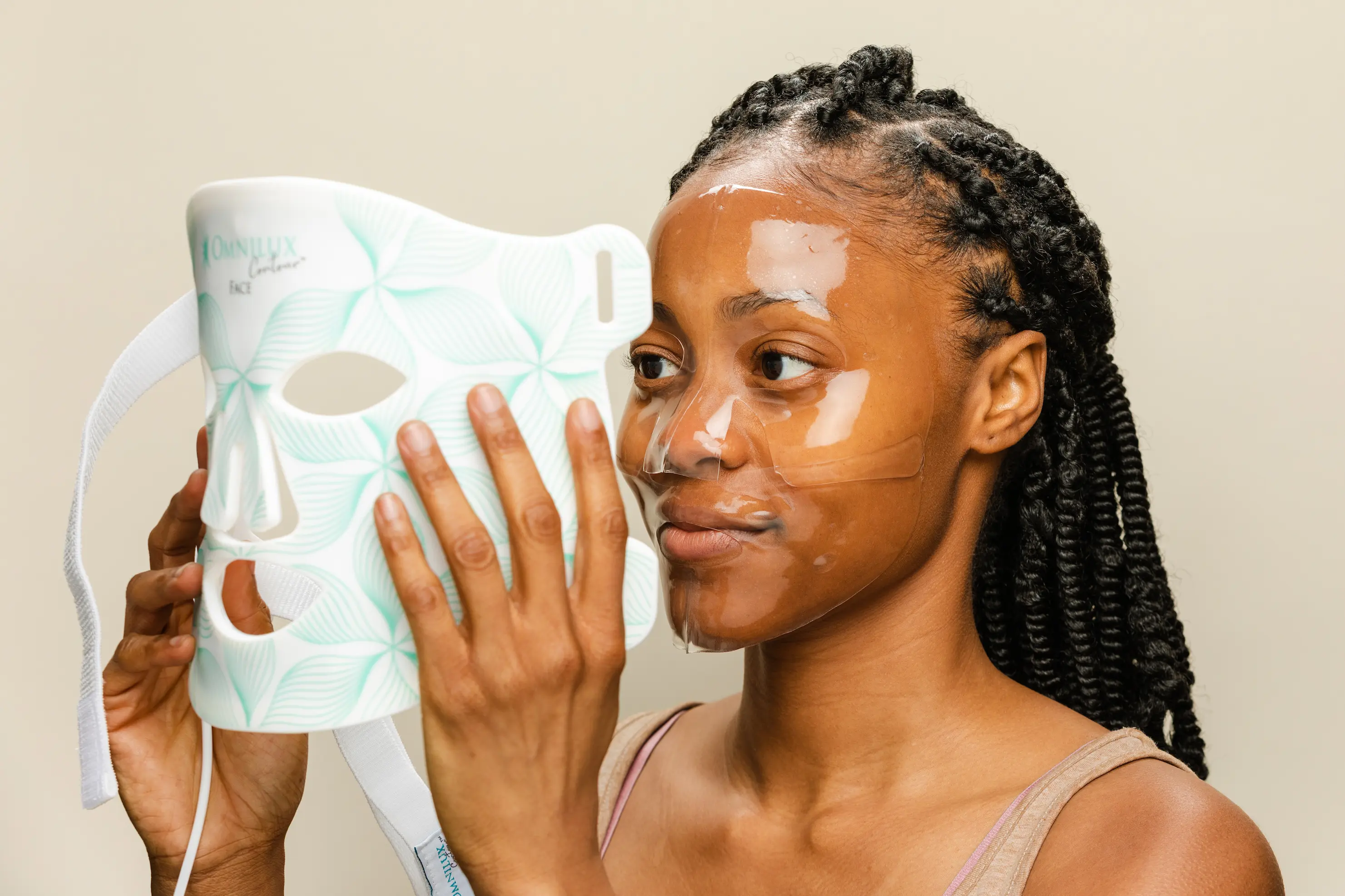 A woman using the Omnilux Contour Face, a revolutionary home skincare device