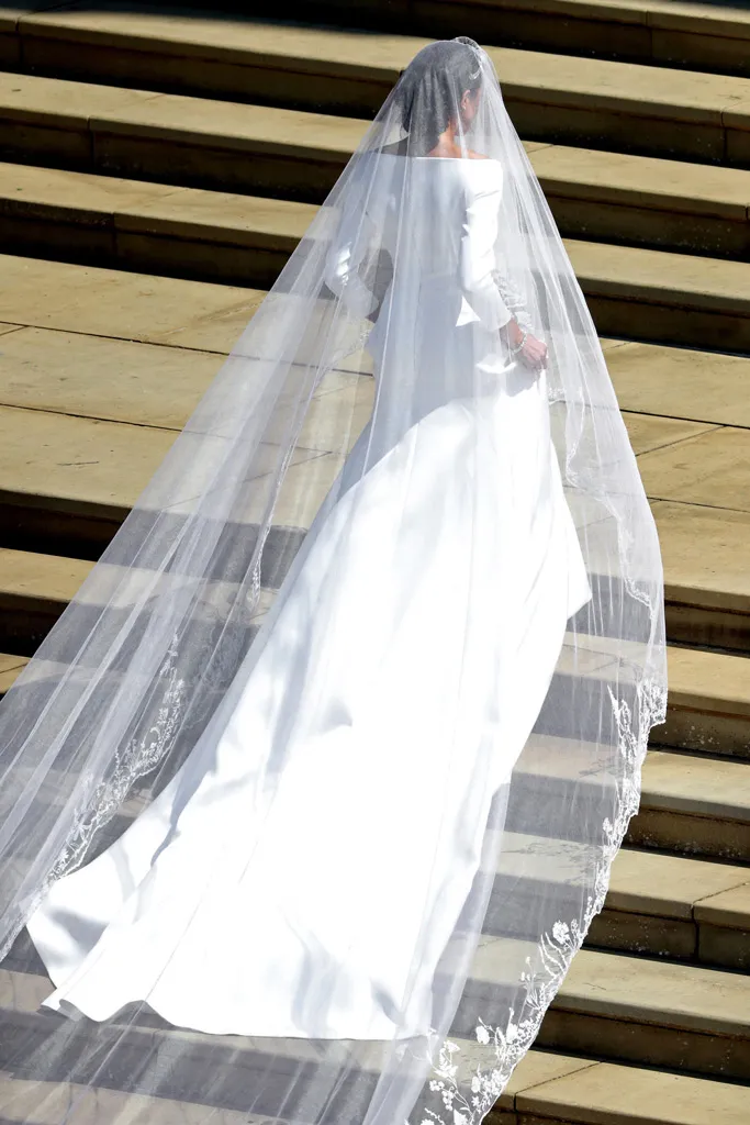 Meghan Markle climbing the staircase at St. George's Chapel in Windsor Castle - Featuring Meghan Markle's Wedding Dress
