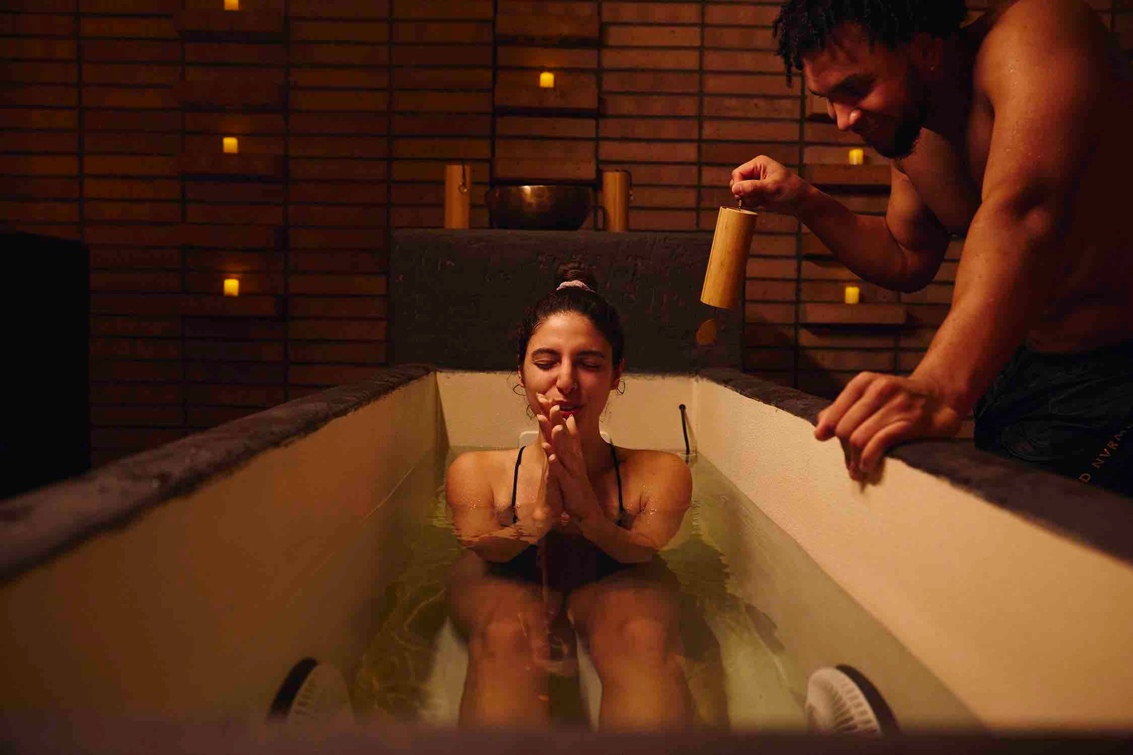 A woman in an ice bath practicing guided mindfulness.