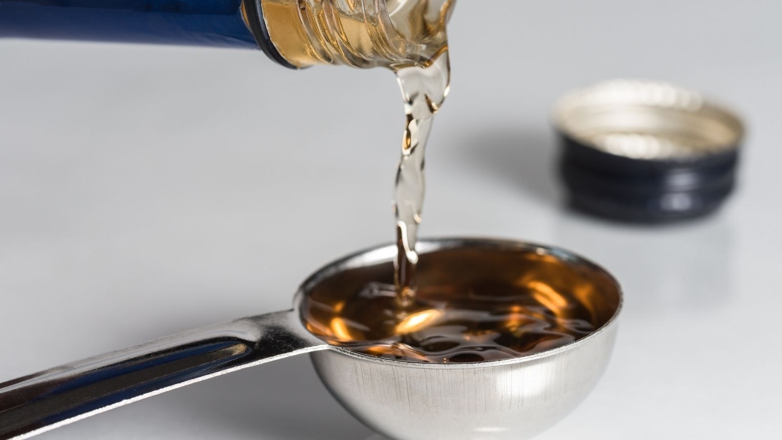 Pouring vinegar into a measuring spoon