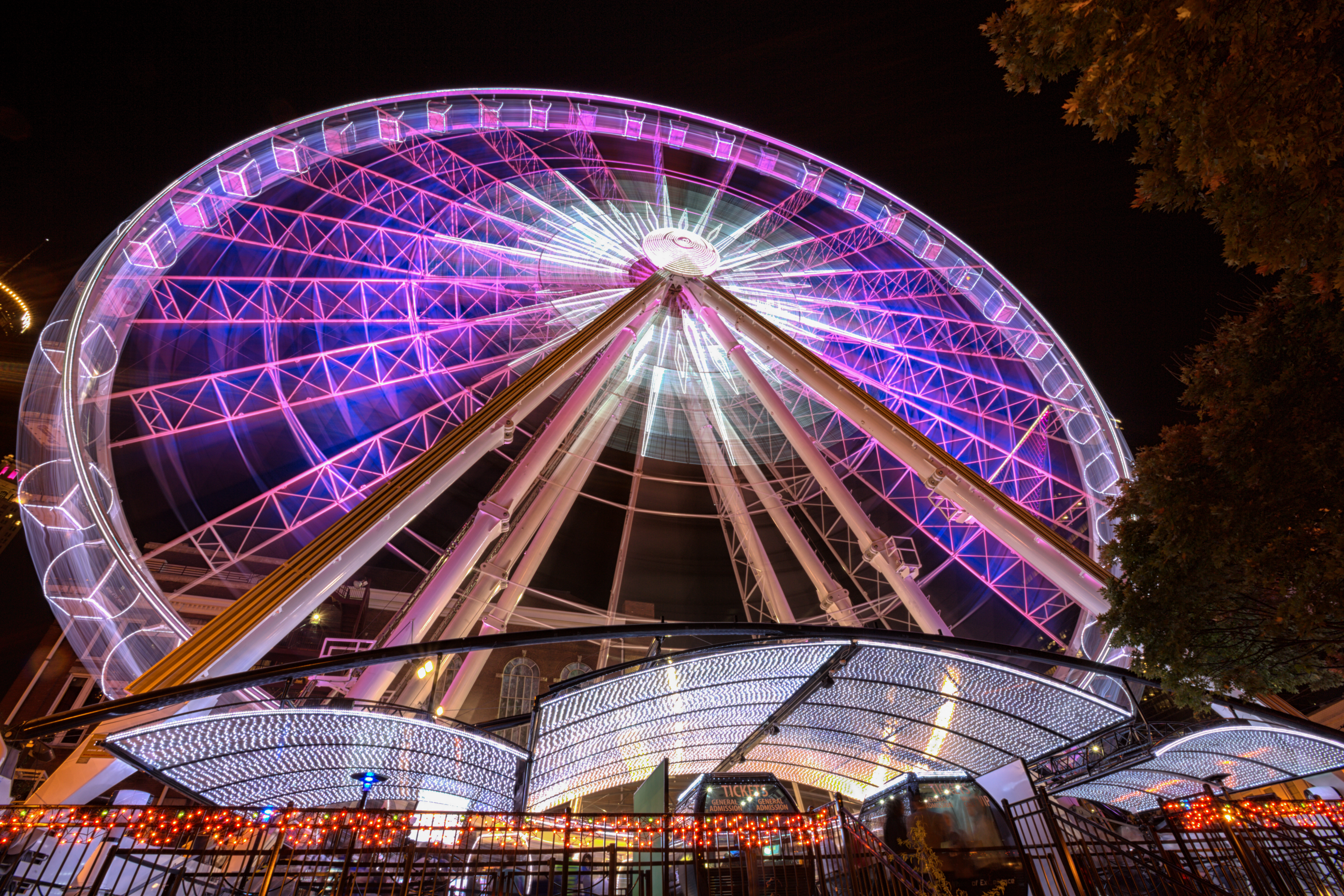 Blurred motion shot of a colorful ferris wheel at night