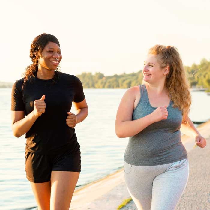 Benefits of Vitamin B Complex Supplements - Two women enjoying a morning jog along the waterfront.