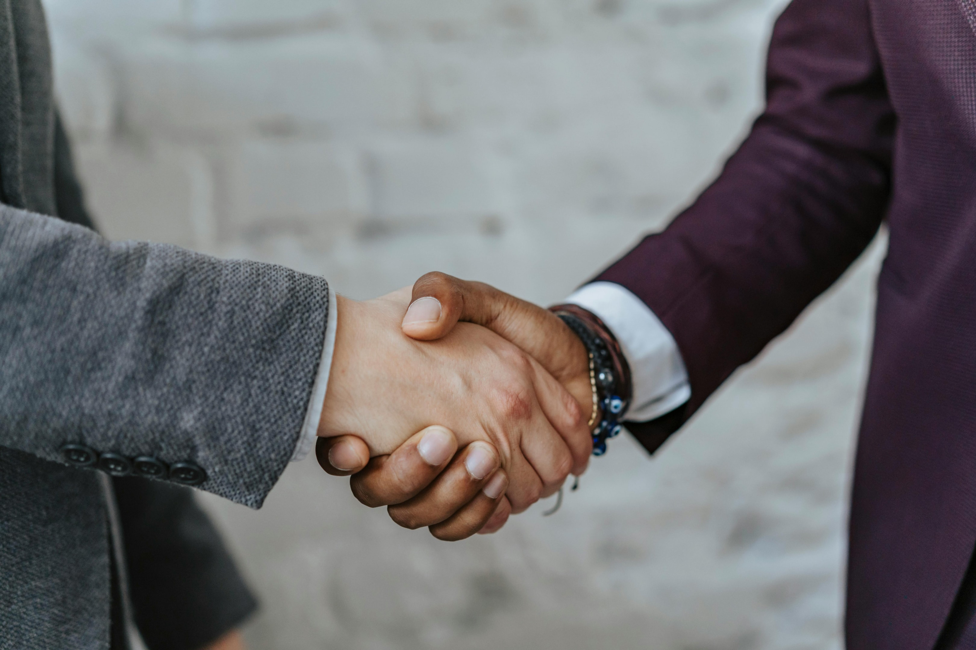 Handshake between real estate investor and home seller after successful purchase of property in probate.