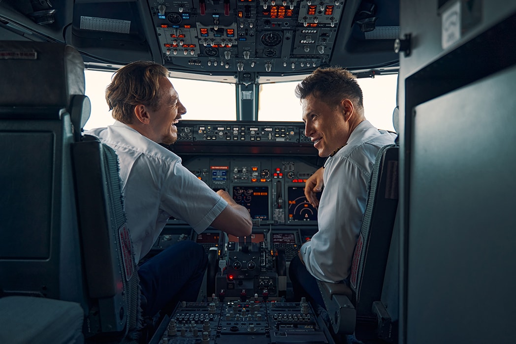 A cockpit scene showing a co pilot and captain working together during a flight.