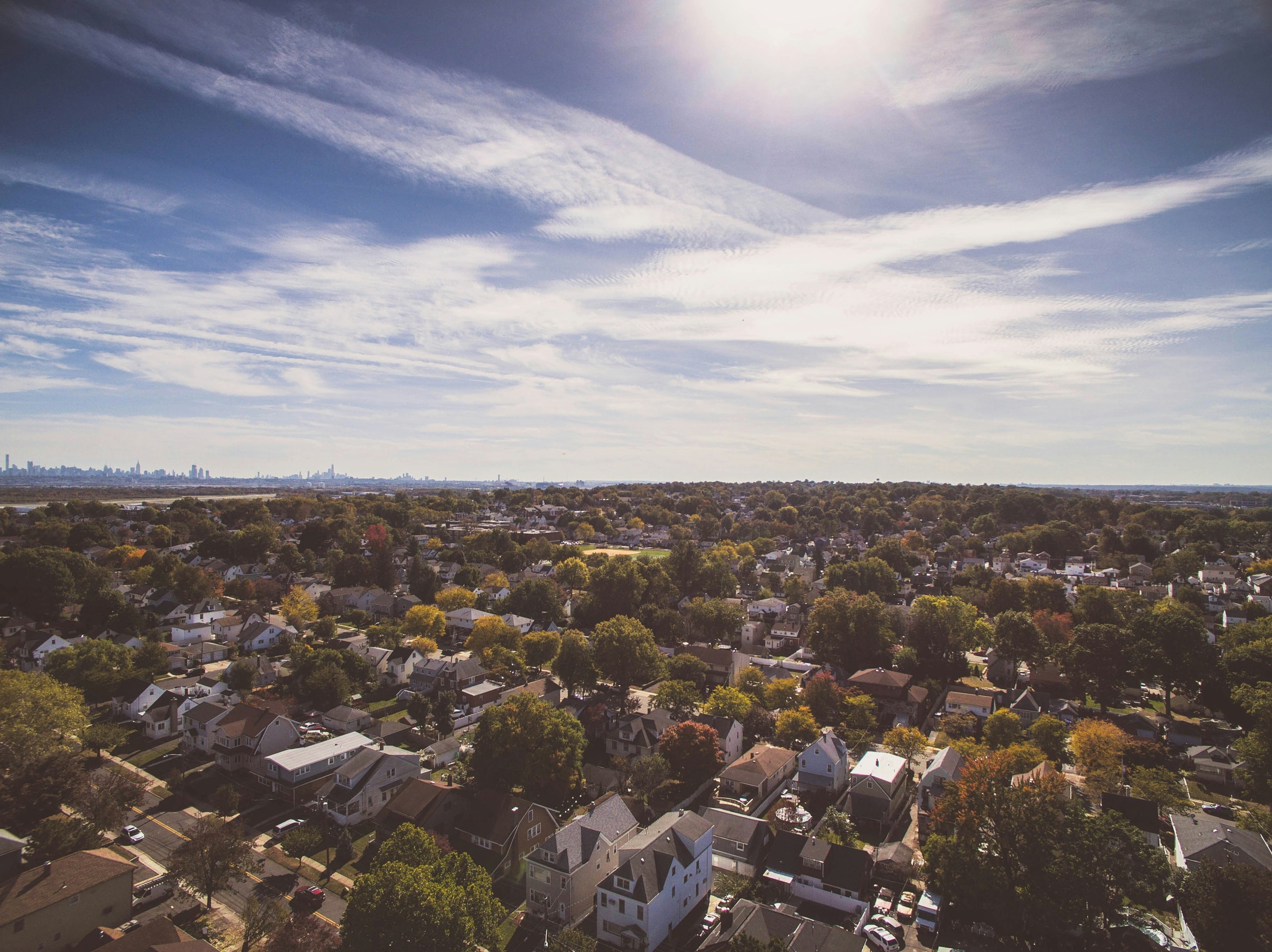 Aerial view of suburban neighborhood with multiple homes for sale. 