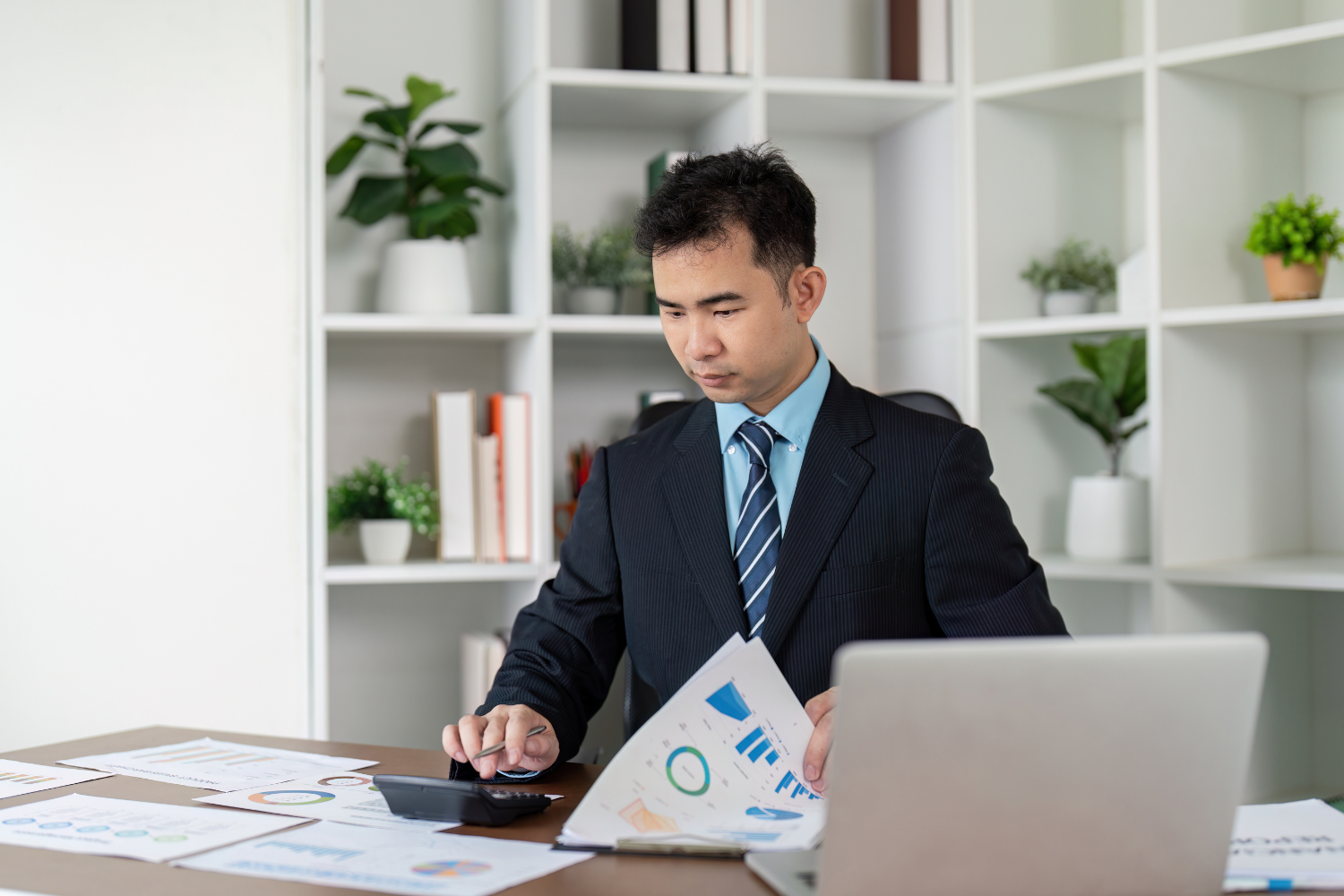 Business owner reviewing broker reports.
