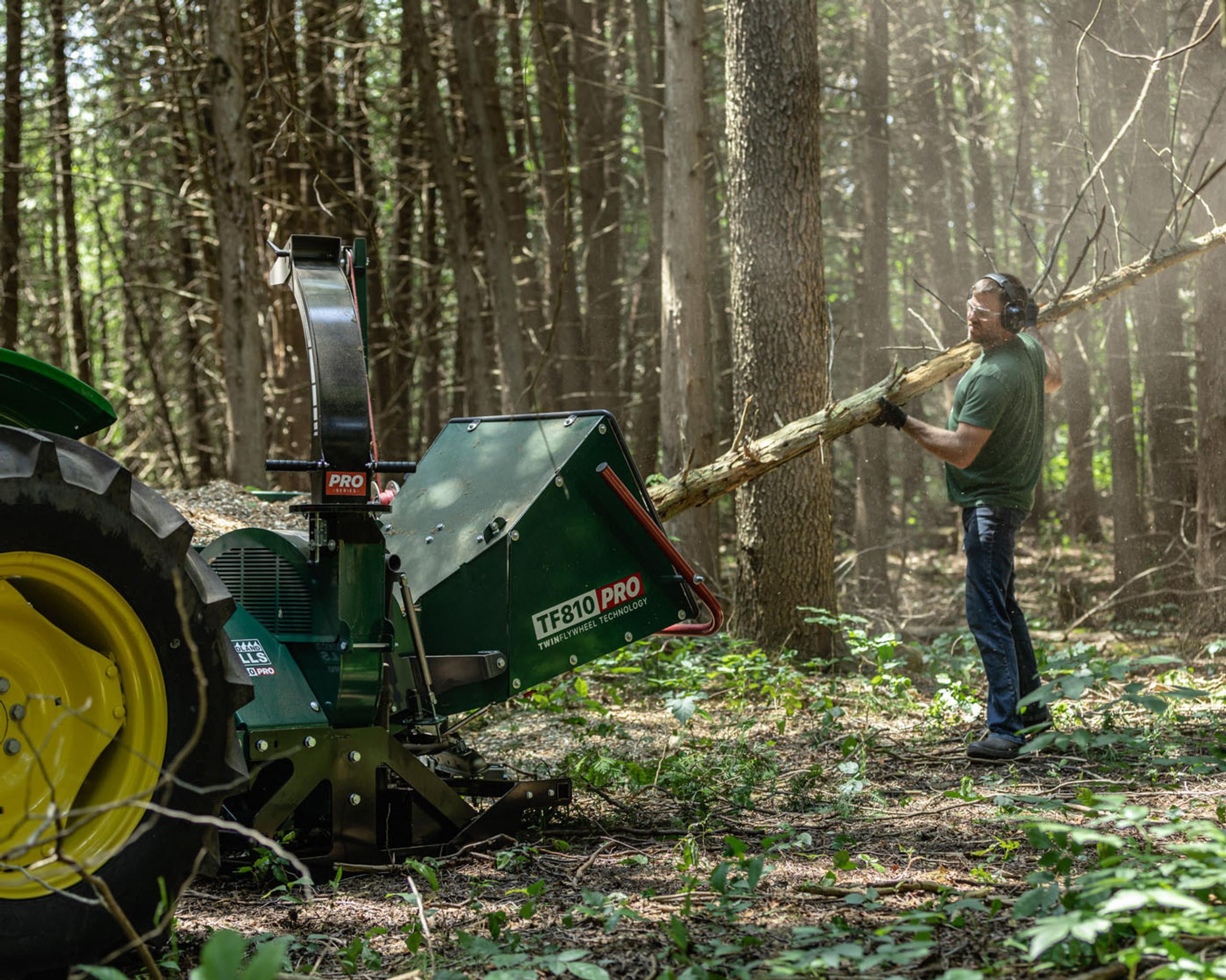 A tree being fed into a Woodland Mills wood chipper.