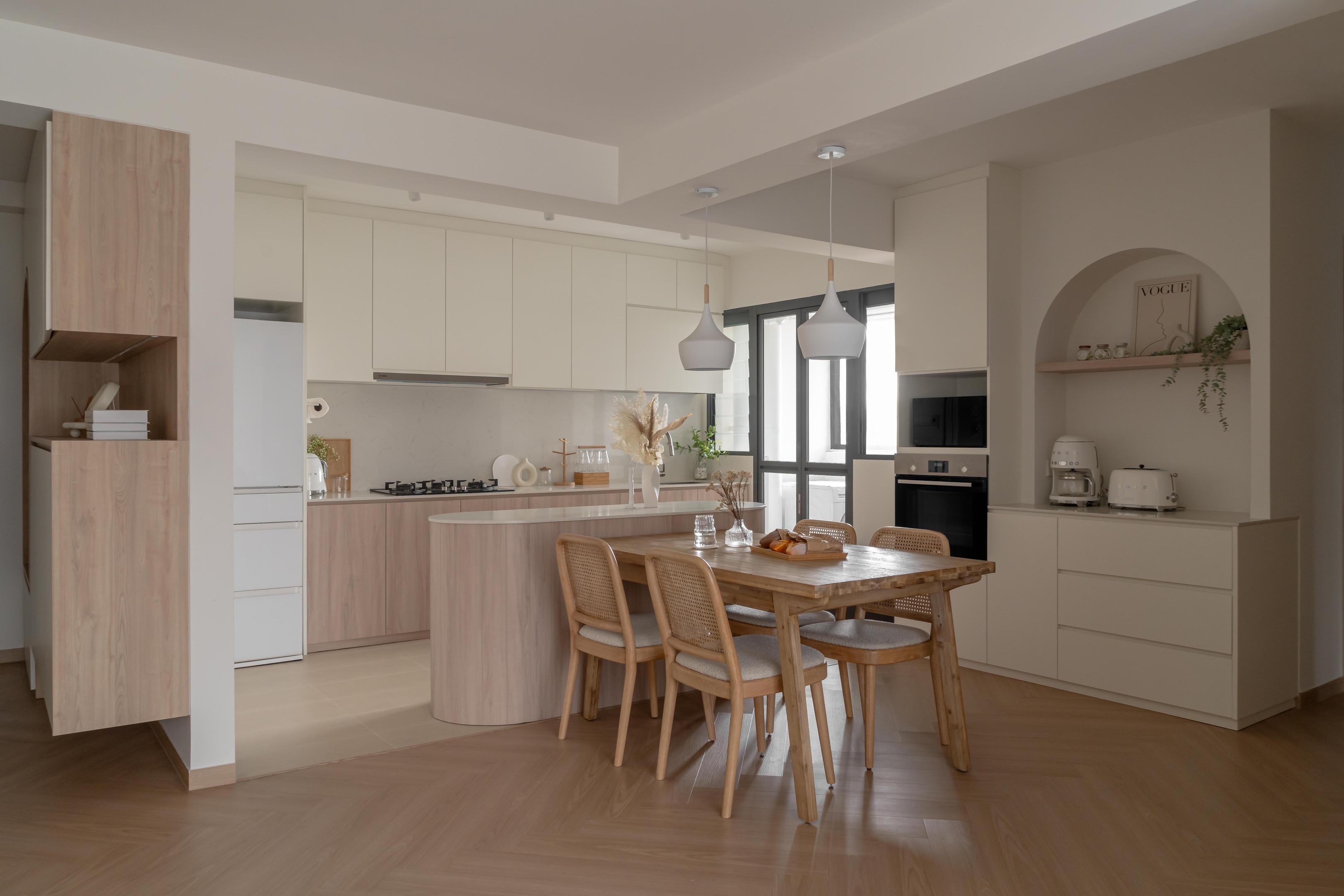 Modern Japandi interior design featuring an open-plan kitchen with a curved island, herringbone wood flooring, and a wooden dining set with rattan chairs.
