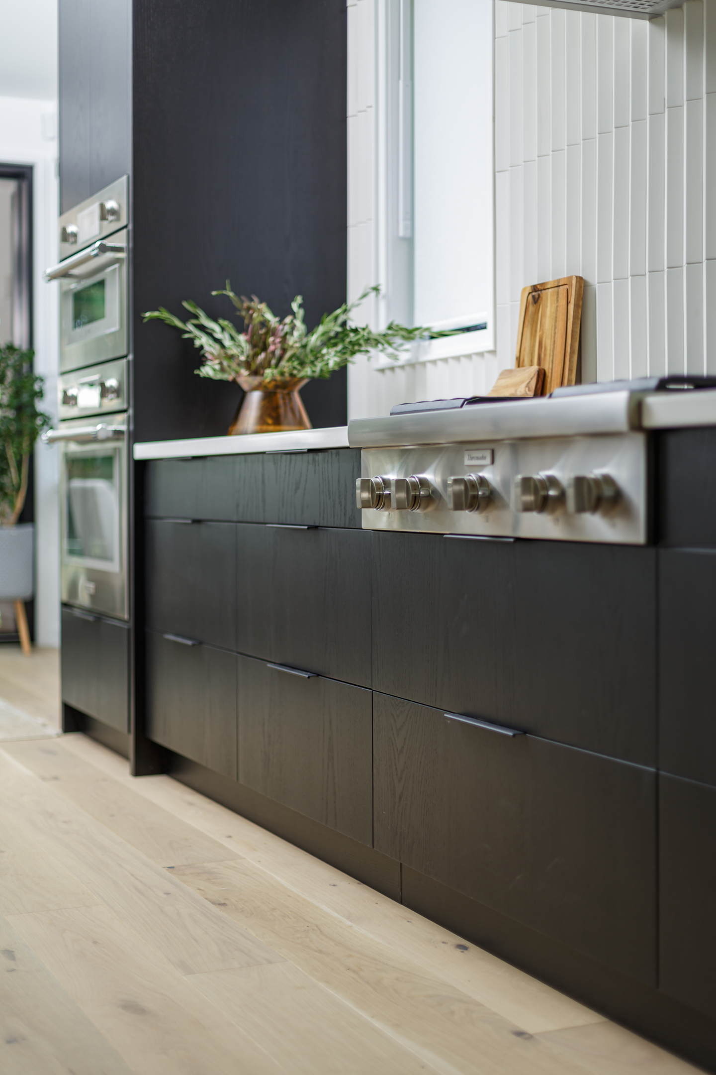 black kitchen cabinets with stainless steel appliances