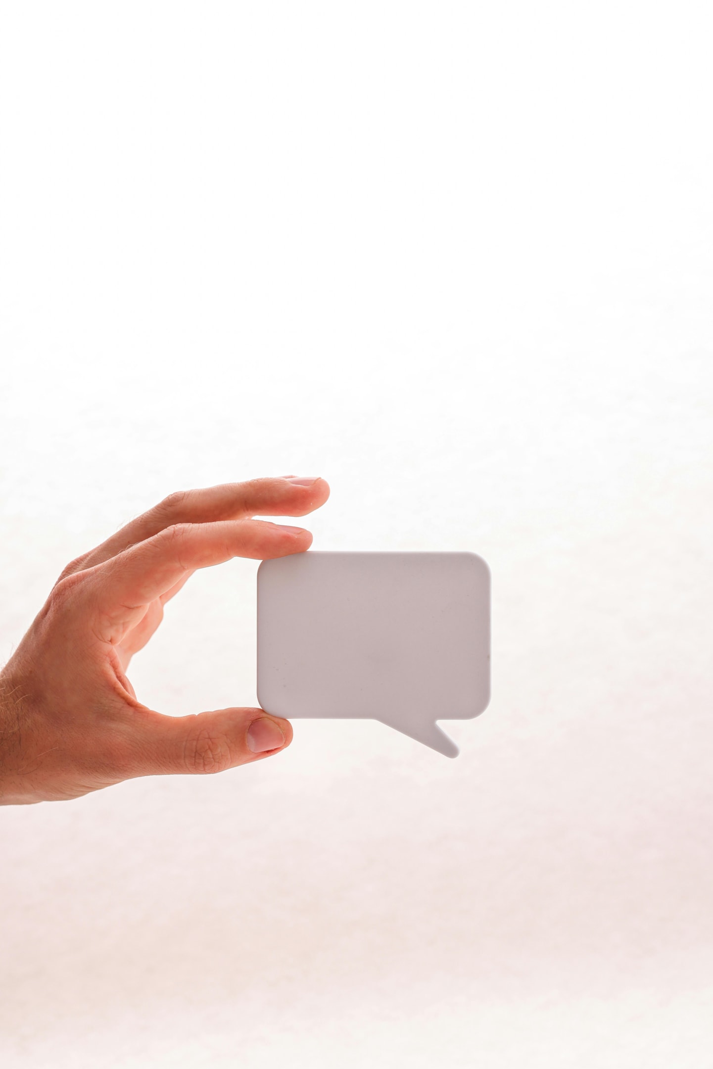 Real estate investor holding cutout of text bubble.