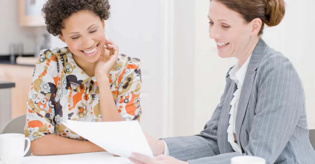 OnlyFans creator reviewing tax paperwork and planning her business structure with a tax advisor related to can an S corp own an LLC.