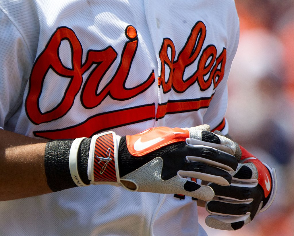 A pair of batting gloves with leather palms and synthetic materials