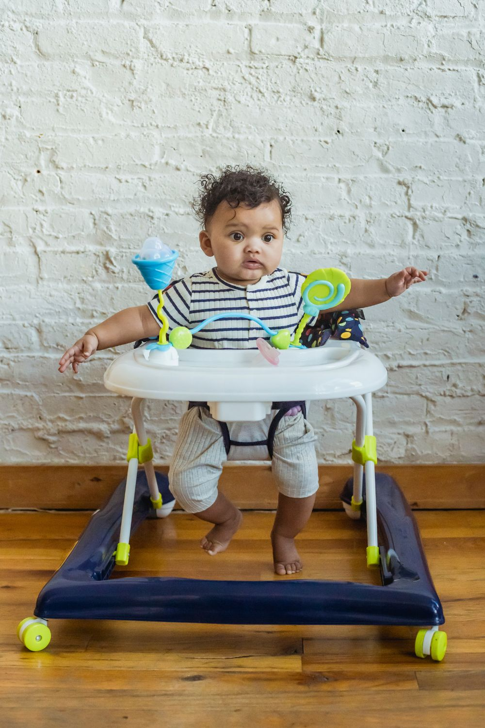 What is a baby walker? featuring a baby on a walker