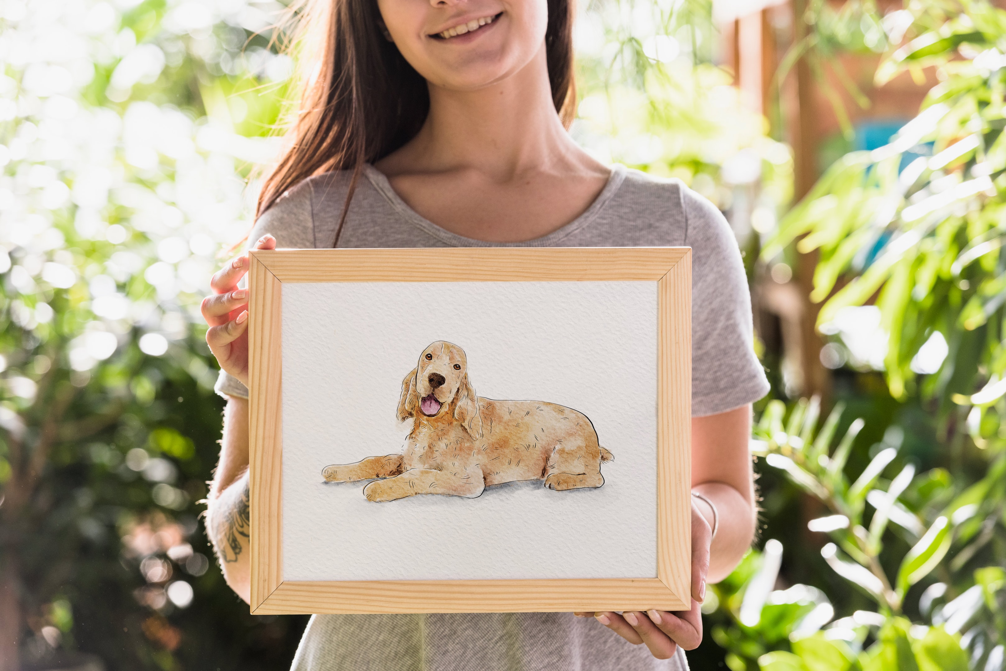 An artist working on a custom pet portrait with a focused expression.