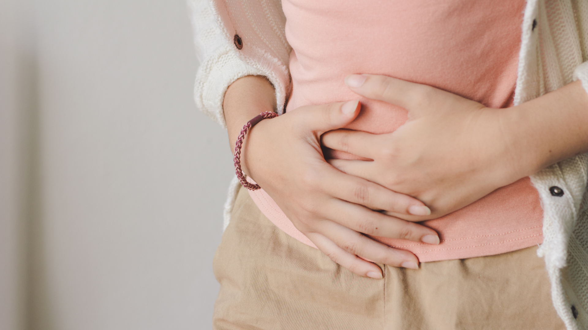 woman holding her abdomen