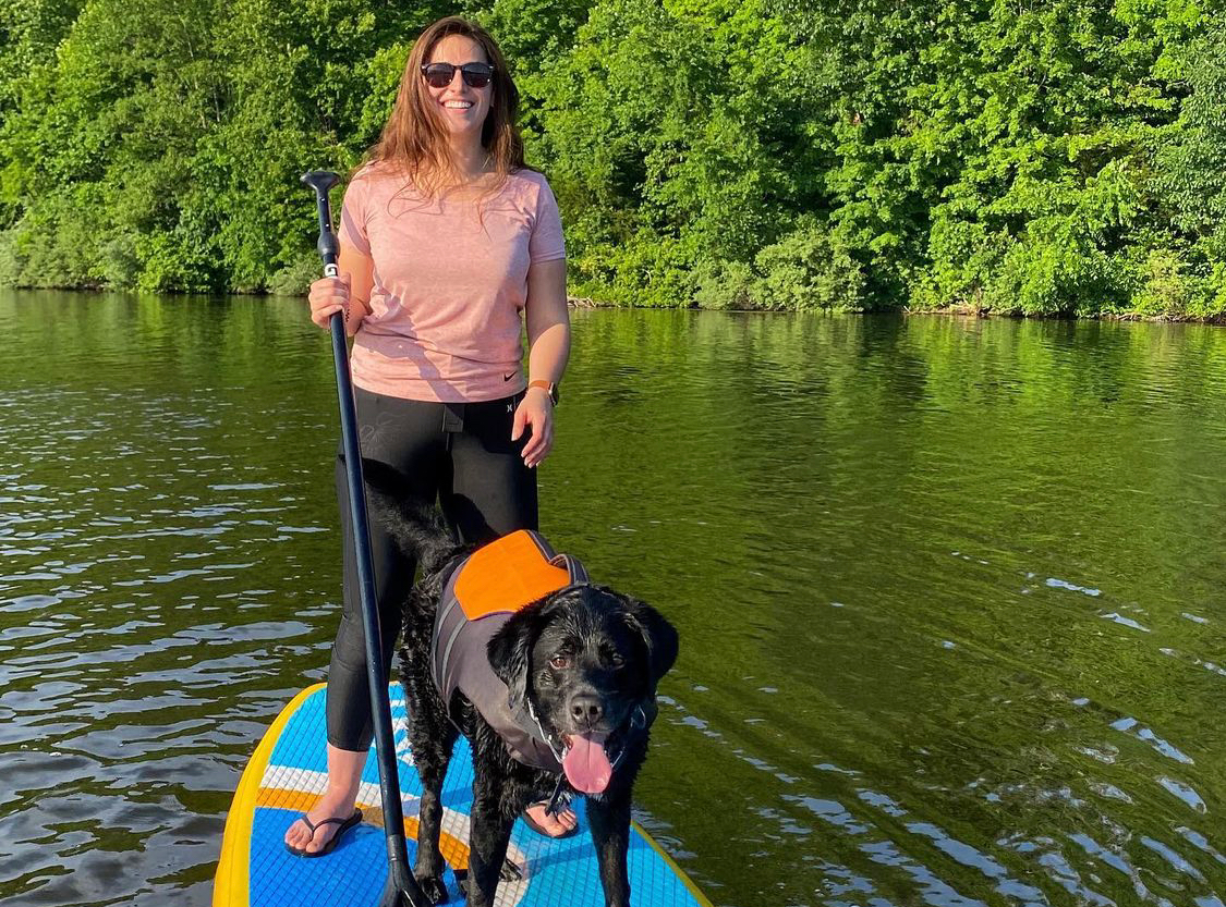 dog on inflatable stand up paddle board