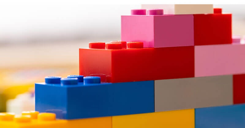 Lego building blocks representing the internal and external factors behind a missing foundation.