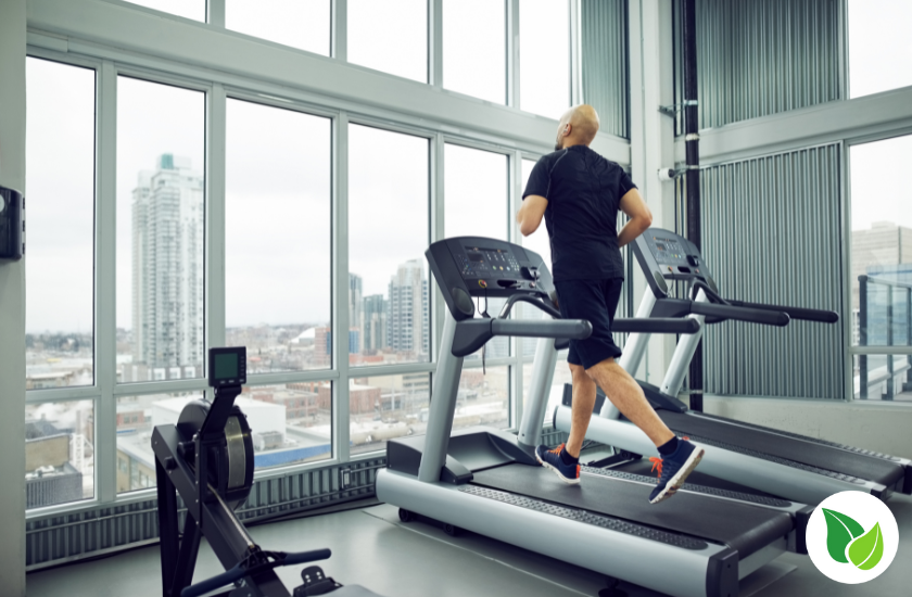 Man running on a treadmill in a post about Does Cardio Kill Gains?