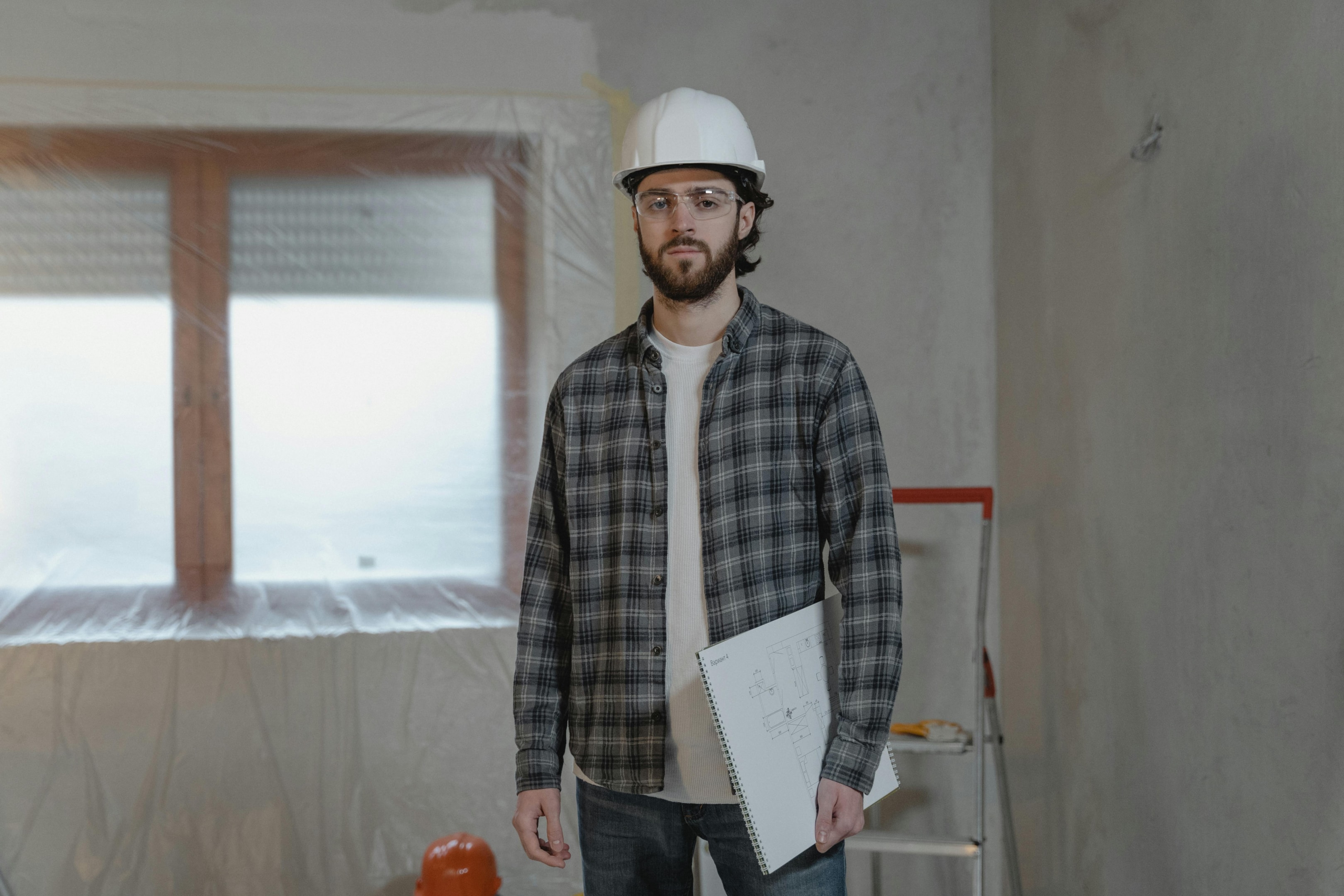 Contractor working inside house that is in the midst of a renovation.