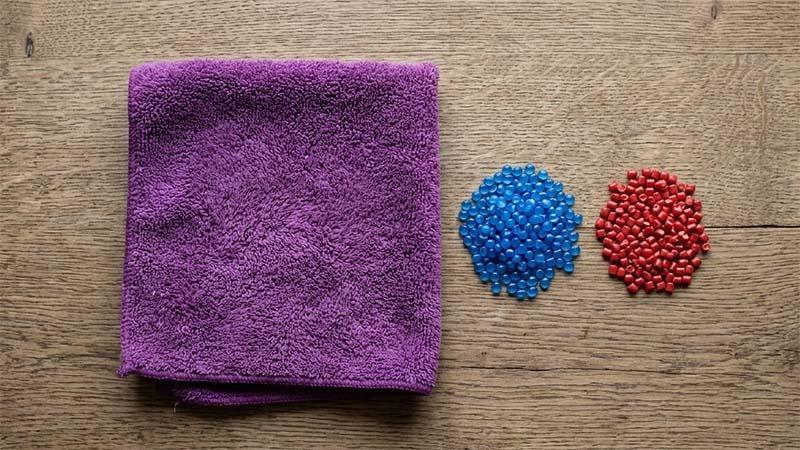 Purple microfiber next to blue polyester and red polyamide pellets
