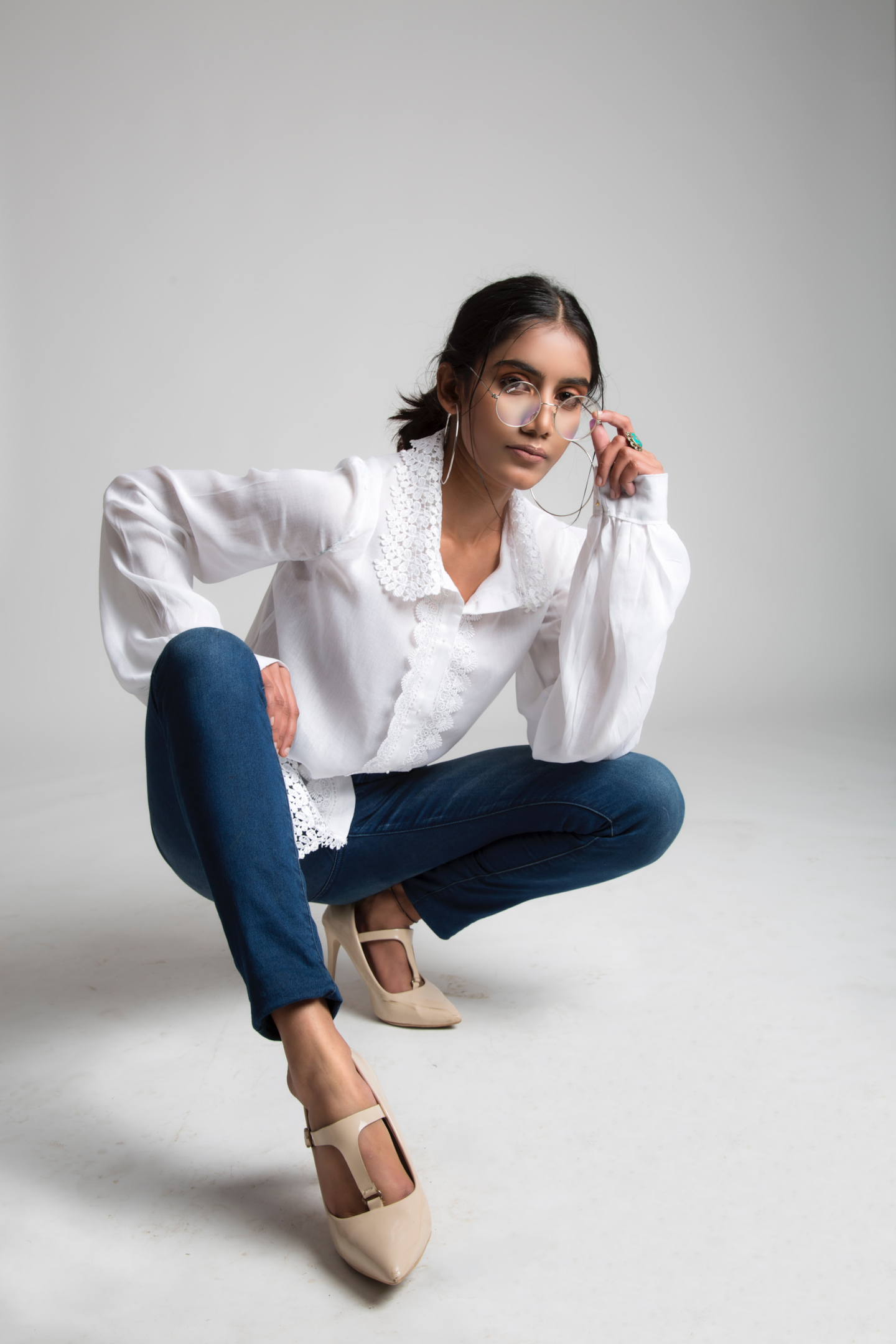 The casual combination of white shirt and jeans is elevated with luxury fashion pieces. | Photo by Anubhaw Anand via Pexels