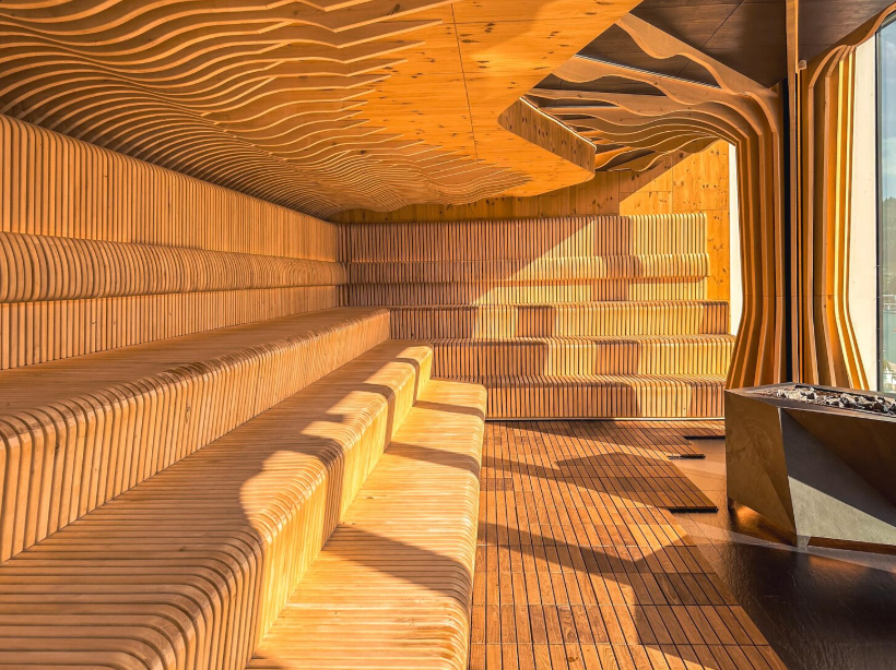 Modern wooden sauna interior with tiered benches.