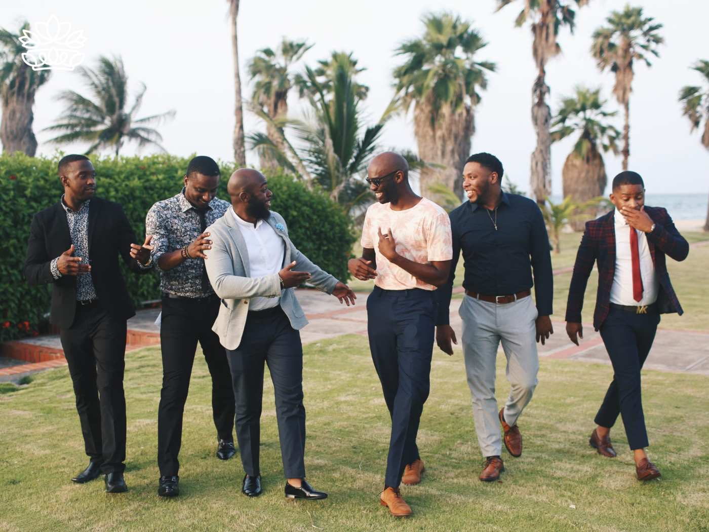 A group of stylish men walking together and chatting outdoors, representing the Gift Boxes for Men Collection - Packed with nuts and budget-friendly options - Fabulous Flowers and Gifts